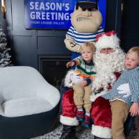 Santa and Louie pose with two boys